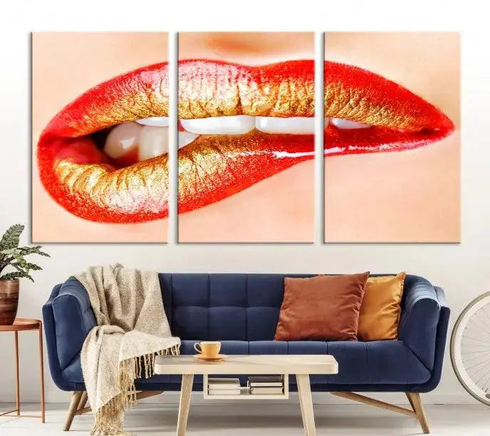 The Red Lip Bite Canvas Print, featuring a triptych of lips with red and gold lipstick, is elegantly displayed, enhancing the modern aesthetic of the minimalist room decor. This artwork is printed on high-quality polycotton canvas.