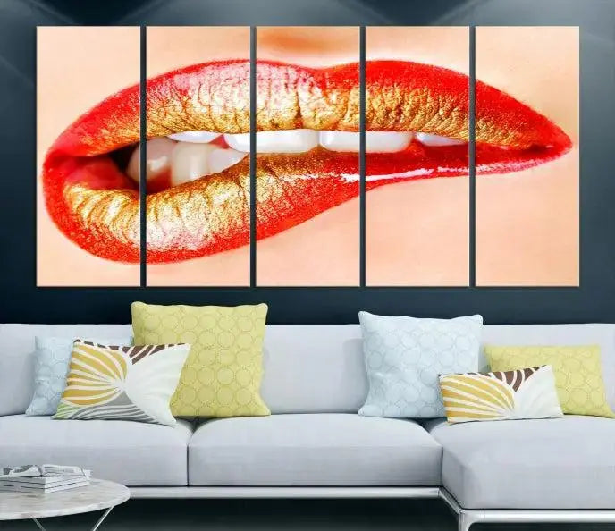 The Red Lip Bite Canvas Print, featuring a triptych of lips with red and gold lipstick, is elegantly displayed, enhancing the modern aesthetic of the minimalist room decor. This artwork is printed on high-quality polycotton canvas.