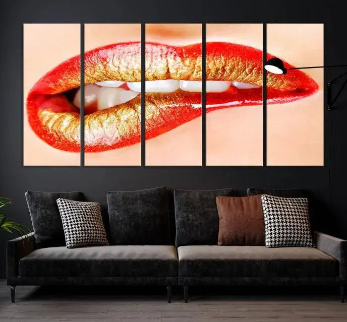 The Red Lip Bite Canvas Print, featuring a triptych of lips with red and gold lipstick, is elegantly displayed, enhancing the modern aesthetic of the minimalist room decor. This artwork is printed on high-quality polycotton canvas.