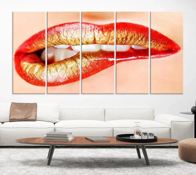 The Red Lip Bite Canvas Print, featuring a triptych of lips with red and gold lipstick, is elegantly displayed, enhancing the modern aesthetic of the minimalist room decor. This artwork is printed on high-quality polycotton canvas.