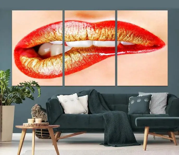 The Red Lip Bite Canvas Print, featuring a triptych of lips with red and gold lipstick, is elegantly displayed, enhancing the modern aesthetic of the minimalist room decor. This artwork is printed on high-quality polycotton canvas.