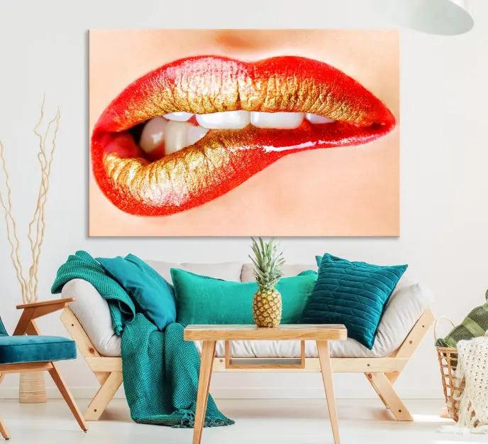 The Red Lip Bite Canvas Print, featuring a triptych of lips with red and gold lipstick, is elegantly displayed, enhancing the modern aesthetic of the minimalist room decor. This artwork is printed on high-quality polycotton canvas.