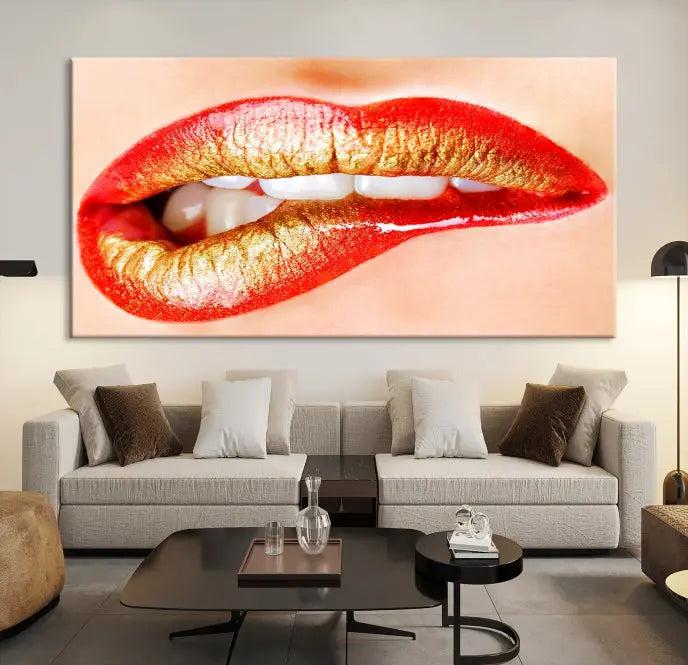 The Red Lip Bite Canvas Print, featuring a triptych of lips with red and gold lipstick, is elegantly displayed, enhancing the modern aesthetic of the minimalist room decor. This artwork is printed on high-quality polycotton canvas.