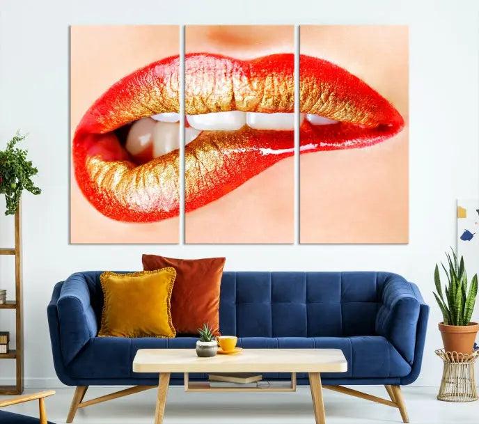 The Red Lip Bite Canvas Print, featuring a triptych of lips with red and gold lipstick, is elegantly displayed, enhancing the modern aesthetic of the minimalist room decor. This artwork is printed on high-quality polycotton canvas.