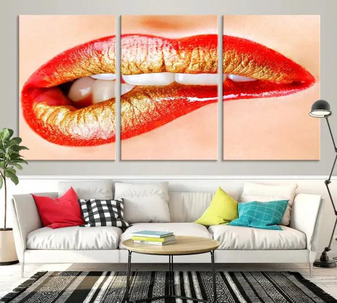 The Red Lip Bite Canvas Print, featuring a triptych of lips with red and gold lipstick, is elegantly displayed, enhancing the modern aesthetic of the minimalist room decor. This artwork is printed on high-quality polycotton canvas.