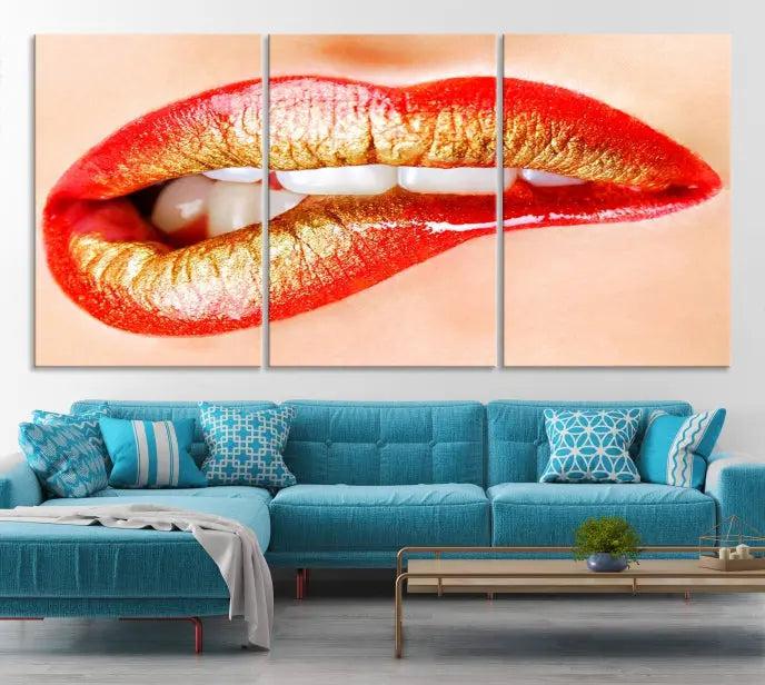 The Red Lip Bite Canvas Print, featuring a triptych of lips with red and gold lipstick, is elegantly displayed, enhancing the modern aesthetic of the minimalist room decor. This artwork is printed on high-quality polycotton canvas.