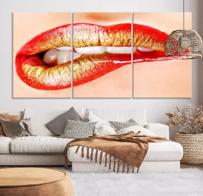 The Red Lip Bite Canvas Print, featuring a triptych of lips with red and gold lipstick, is elegantly displayed, enhancing the modern aesthetic of the minimalist room decor. This artwork is printed on high-quality polycotton canvas.