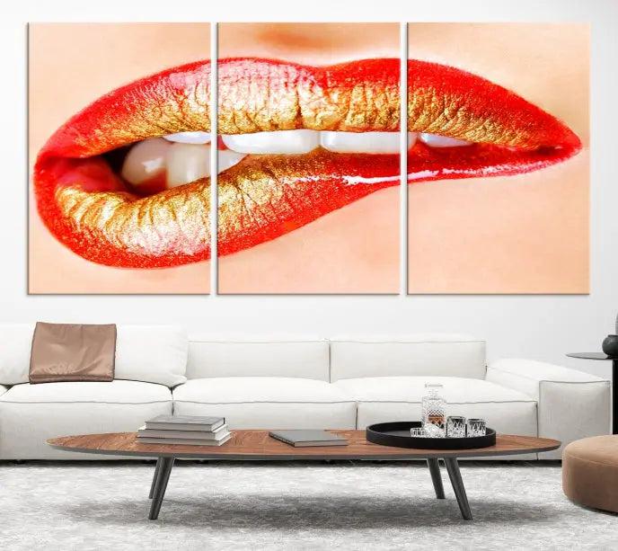 The Red Lip Bite Canvas Print, featuring a triptych of lips with red and gold lipstick, is elegantly displayed, enhancing the modern aesthetic of the minimalist room decor. This artwork is printed on high-quality polycotton canvas.