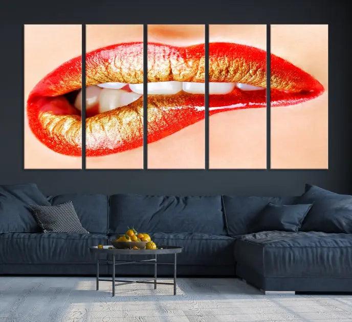 The Red Lip Bite Canvas Print, featuring a triptych of lips with red and gold lipstick, is elegantly displayed, enhancing the modern aesthetic of the minimalist room decor. This artwork is printed on high-quality polycotton canvas.