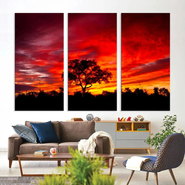 The living room features a hand-assembled triptych of the Red Sunset Landscape Artwork Printing, showing a fiery sunset over a forest tree. This piece, printed on museum-quality canvas, adds an artistic touch to the space.