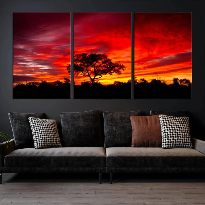 The living room features a hand-assembled triptych of the Red Sunset Landscape Artwork Printing, showing a fiery sunset over a forest tree. This piece, printed on museum-quality canvas, adds an artistic touch to the space.