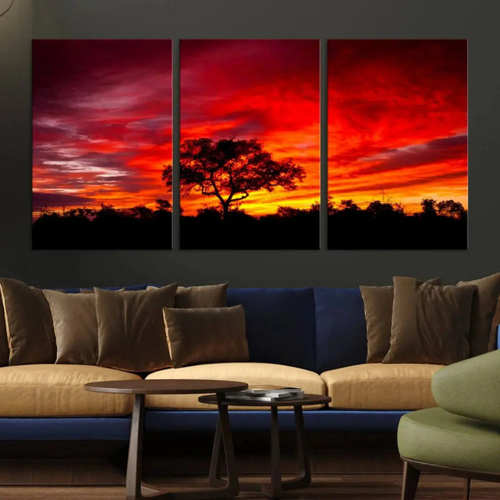 The living room features a hand-assembled triptych of the Red Sunset Landscape Artwork Printing, showing a fiery sunset over a forest tree. This piece, printed on museum-quality canvas, adds an artistic touch to the space.