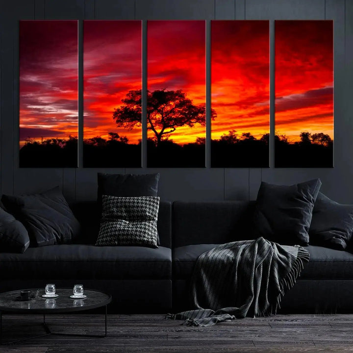 The living room features a hand-assembled triptych of the Red Sunset Landscape Artwork Printing, showing a fiery sunset over a forest tree. This piece, printed on museum-quality canvas, adds an artistic touch to the space.