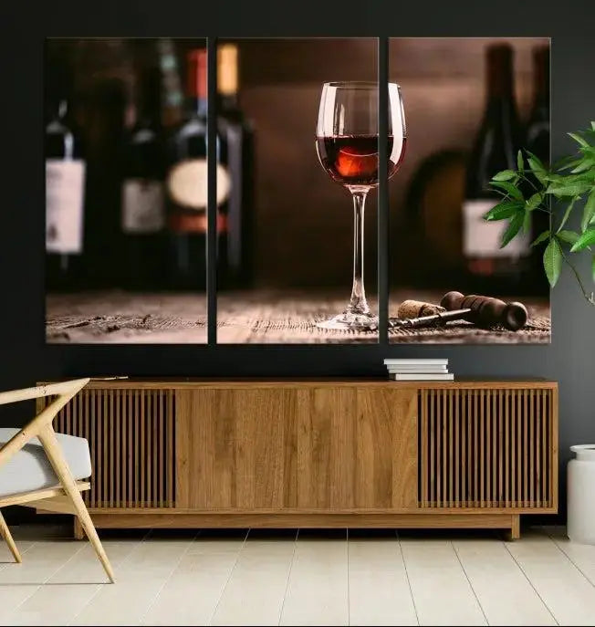 The "Red Wine and Bottle Canvas Print" is a triptych on museum-quality canvas, featuring a glass of red wine with subtle depictions of wine bottles and corks in the background, all beautifully gallery wrapped.