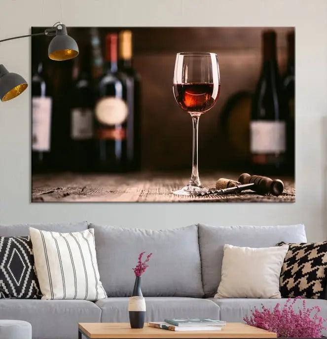 The "Red Wine and Bottle Canvas Print" is a triptych on museum-quality canvas, featuring a glass of red wine with subtle depictions of wine bottles and corks in the background, all beautifully gallery wrapped.