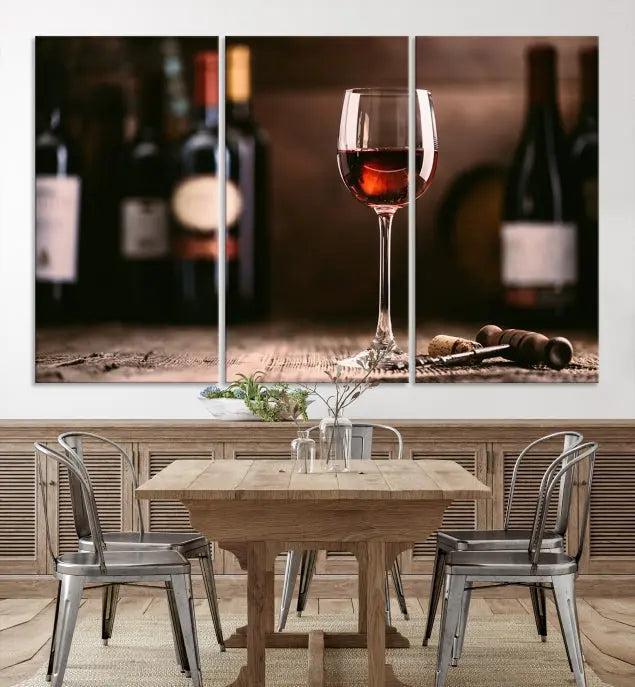 The "Red Wine and Bottle Canvas Print" is a triptych on museum-quality canvas, featuring a glass of red wine with subtle depictions of wine bottles and corks in the background, all beautifully gallery wrapped.