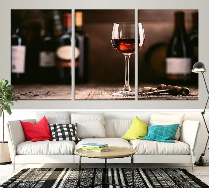 The "Red Wine and Bottle Canvas Print" is a triptych on museum-quality canvas, featuring a glass of red wine with subtle depictions of wine bottles and corks in the background, all beautifully gallery wrapped.