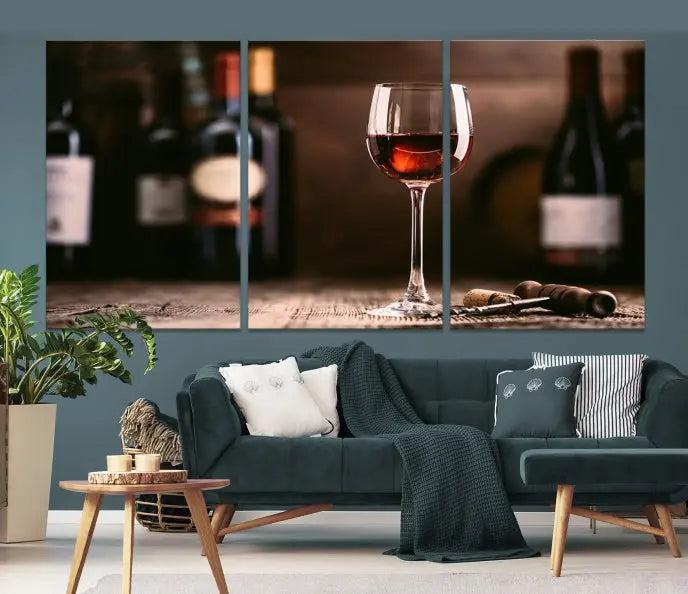 The "Red Wine and Bottle Canvas Print" is a triptych on museum-quality canvas, featuring a glass of red wine with subtle depictions of wine bottles and corks in the background, all beautifully gallery wrapped.