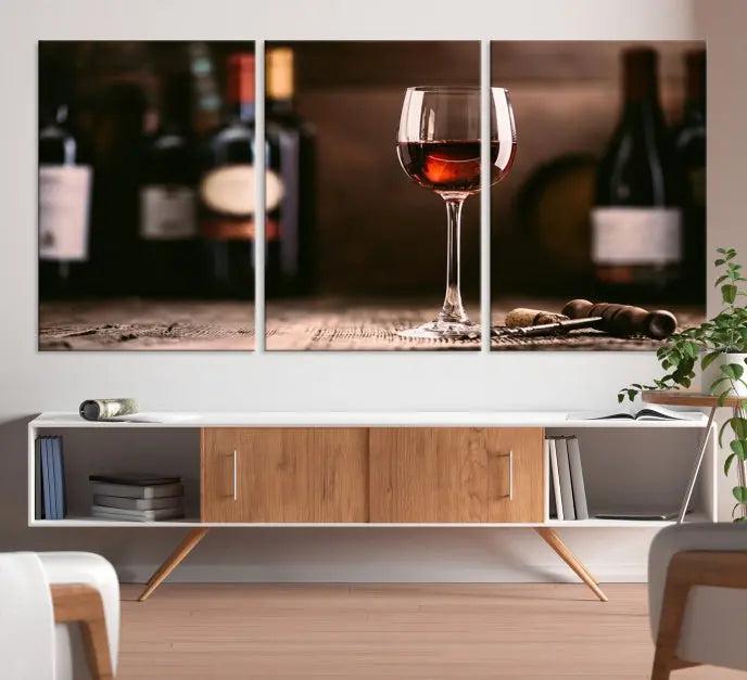 The "Red Wine and Bottle Canvas Print" is a triptych on museum-quality canvas, featuring a glass of red wine with subtle depictions of wine bottles and corks in the background, all beautifully gallery wrapped.