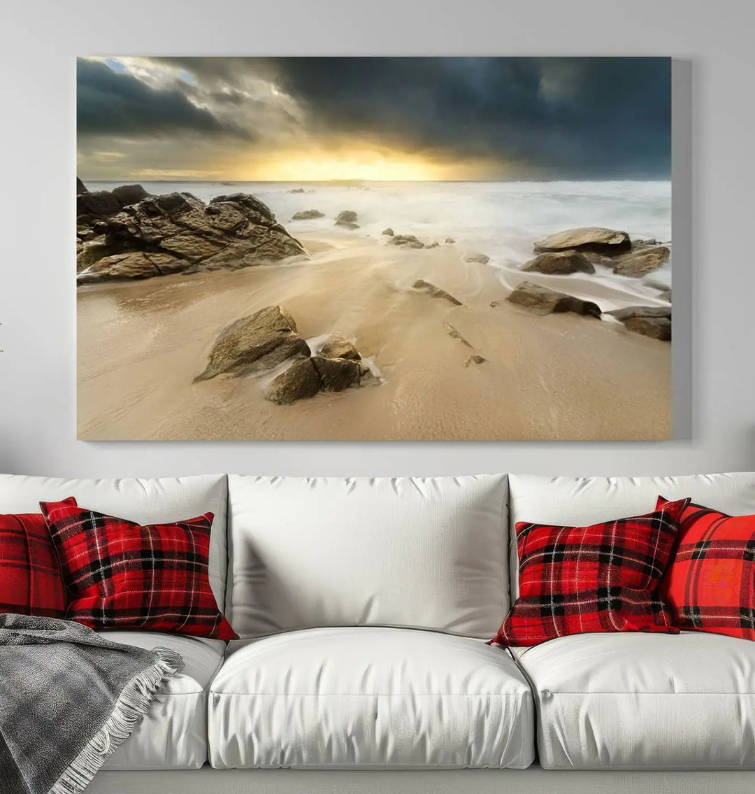 A gallery-wrapped, three-panel artwork titled "Rocks and Waves Wall Art Canvas Print" depicts a rocky beach at sunset. Each canvas showcases museum-quality craftsmanship and a UV-protective coating to maintain its vibrant colors.