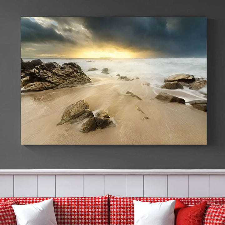 A gallery-wrapped, three-panel artwork titled "Rocks and Waves Wall Art Canvas Print" depicts a rocky beach at sunset. Each canvas showcases museum-quality craftsmanship and a UV-protective coating to maintain its vibrant colors.