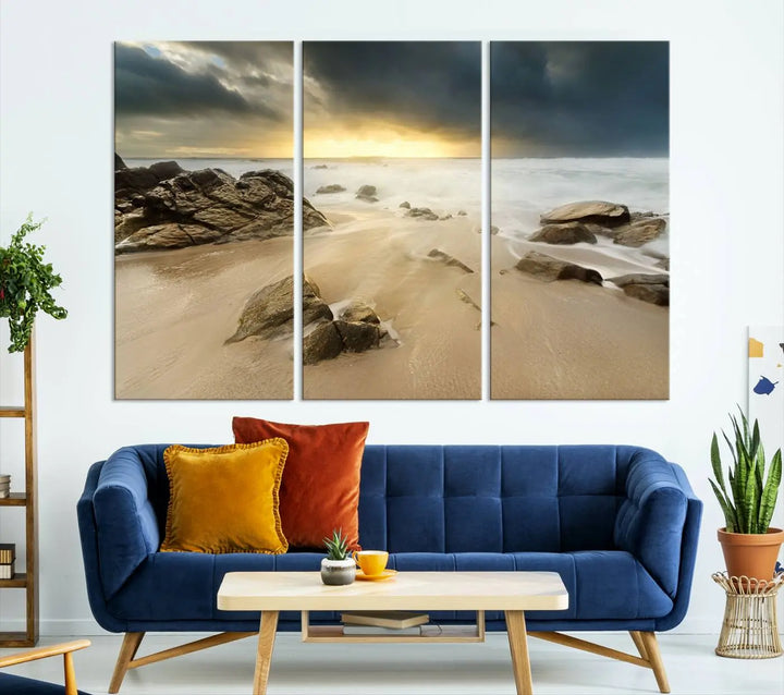 A gallery-wrapped, three-panel artwork titled "Rocks and Waves Wall Art Canvas Print" depicts a rocky beach at sunset. Each canvas showcases museum-quality craftsmanship and a UV-protective coating to maintain its vibrant colors.