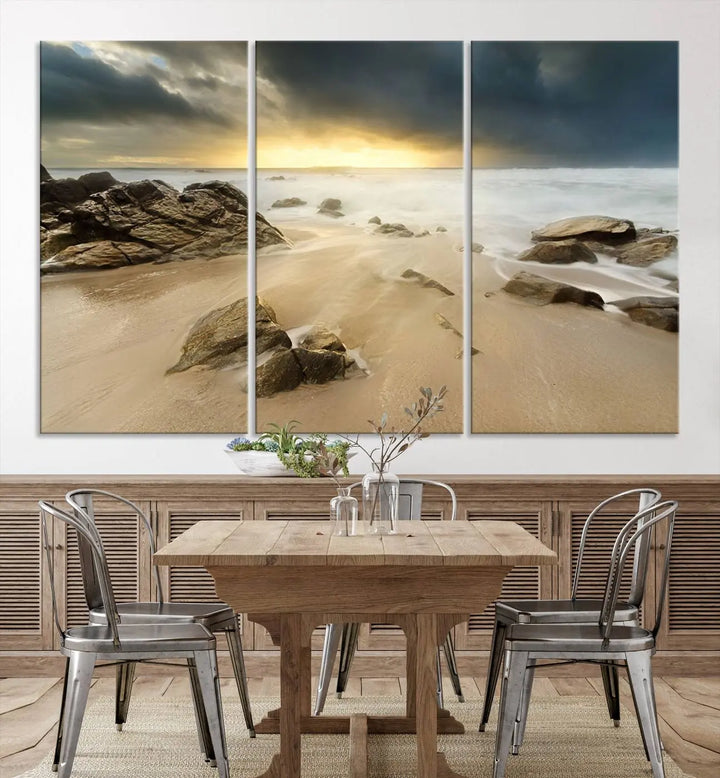 A gallery-wrapped, three-panel artwork titled "Rocks and Waves Wall Art Canvas Print" depicts a rocky beach at sunset. Each canvas showcases museum-quality craftsmanship and a UV-protective coating to maintain its vibrant colors.