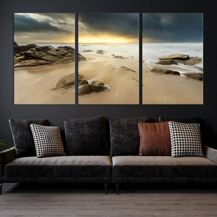 A gallery-wrapped, three-panel artwork titled "Rocks and Waves Wall Art Canvas Print" depicts a rocky beach at sunset. Each canvas showcases museum-quality craftsmanship and a UV-protective coating to maintain its vibrant colors.