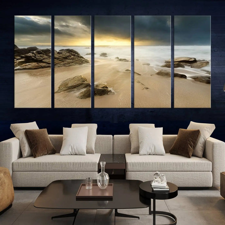 A gallery-wrapped, three-panel artwork titled "Rocks and Waves Wall Art Canvas Print" depicts a rocky beach at sunset. Each canvas showcases museum-quality craftsmanship and a UV-protective coating to maintain its vibrant colors.