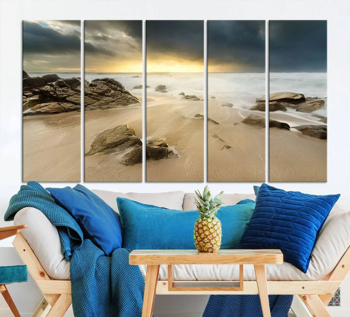 A gallery-wrapped, three-panel artwork titled "Rocks and Waves Wall Art Canvas Print" depicts a rocky beach at sunset. Each canvas showcases museum-quality craftsmanship and a UV-protective coating to maintain its vibrant colors.