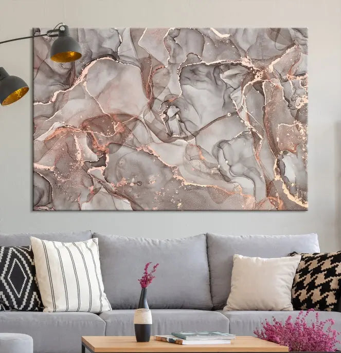 The Rose Gold Marble Fluid Effect Wall Art Abstract Canvas Wall Art Print is an exquisite three-panel creation crafted on museum-quality canvas. It features swirling marbled patterns in shades of gray, copper, and beige. Complete with a UV-protective coating, this ready-to-hang artwork promises to be a timeless addition to any space.