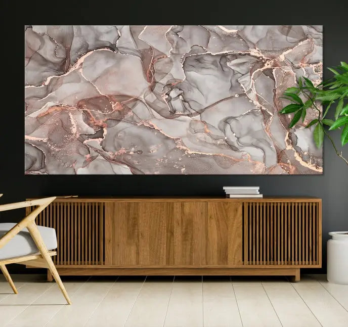 The Rose Gold Marble Fluid Effect Wall Art Abstract Canvas Wall Art Print is an exquisite three-panel creation crafted on museum-quality canvas. It features swirling marbled patterns in shades of gray, copper, and beige. Complete with a UV-protective coating, this ready-to-hang artwork promises to be a timeless addition to any space.