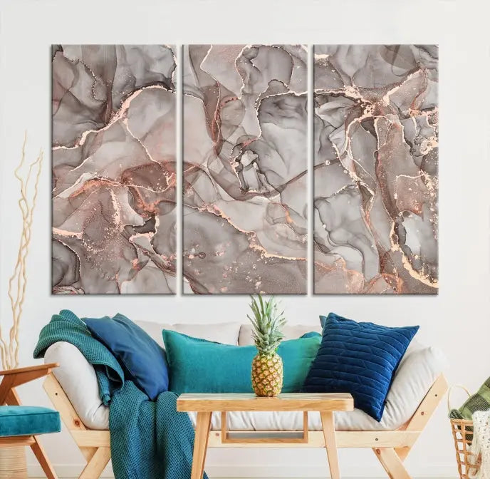 The Rose Gold Marble Fluid Effect Wall Art Abstract Canvas Wall Art Print is an exquisite three-panel creation crafted on museum-quality canvas. It features swirling marbled patterns in shades of gray, copper, and beige. Complete with a UV-protective coating, this ready-to-hang artwork promises to be a timeless addition to any space.