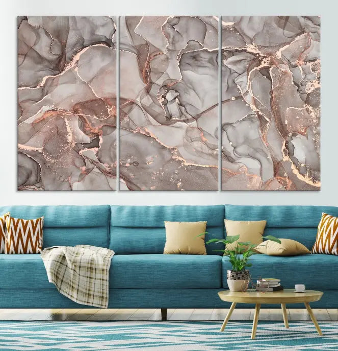 The Rose Gold Marble Fluid Effect Wall Art Abstract Canvas Wall Art Print is an exquisite three-panel creation crafted on museum-quality canvas. It features swirling marbled patterns in shades of gray, copper, and beige. Complete with a UV-protective coating, this ready-to-hang artwork promises to be a timeless addition to any space.