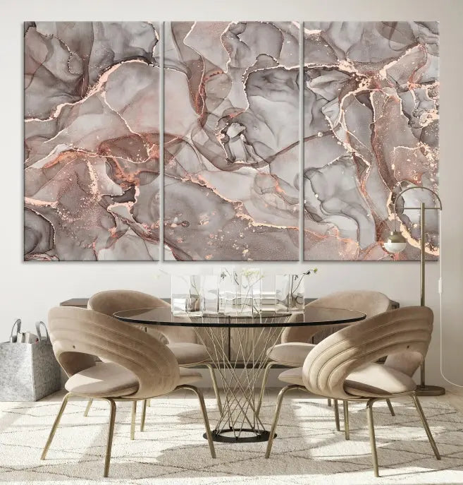 The Rose Gold Marble Fluid Effect Wall Art Abstract Canvas Wall Art Print is an exquisite three-panel creation crafted on museum-quality canvas. It features swirling marbled patterns in shades of gray, copper, and beige. Complete with a UV-protective coating, this ready-to-hang artwork promises to be a timeless addition to any space.