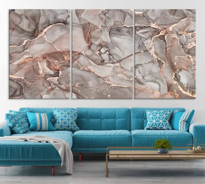 The Rose Gold Marble Fluid Effect Wall Art Abstract Canvas Wall Art Print is an exquisite three-panel creation crafted on museum-quality canvas. It features swirling marbled patterns in shades of gray, copper, and beige. Complete with a UV-protective coating, this ready-to-hang artwork promises to be a timeless addition to any space.