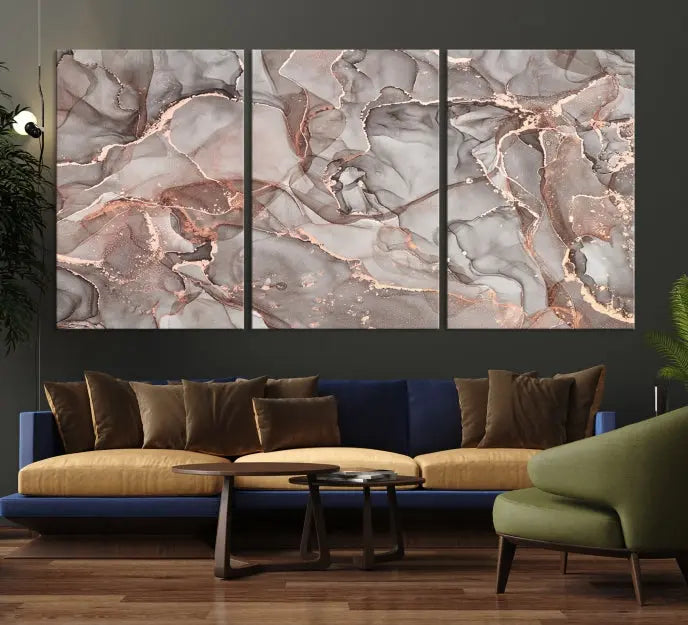 The Rose Gold Marble Fluid Effect Wall Art Abstract Canvas Wall Art Print is an exquisite three-panel creation crafted on museum-quality canvas. It features swirling marbled patterns in shades of gray, copper, and beige. Complete with a UV-protective coating, this ready-to-hang artwork promises to be a timeless addition to any space.