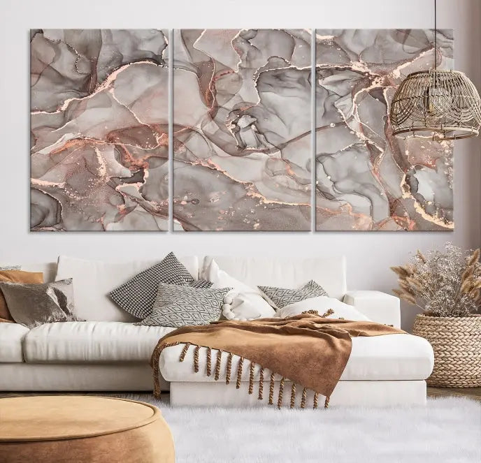 The Rose Gold Marble Fluid Effect Wall Art Abstract Canvas Wall Art Print is an exquisite three-panel creation crafted on museum-quality canvas. It features swirling marbled patterns in shades of gray, copper, and beige. Complete with a UV-protective coating, this ready-to-hang artwork promises to be a timeless addition to any space.