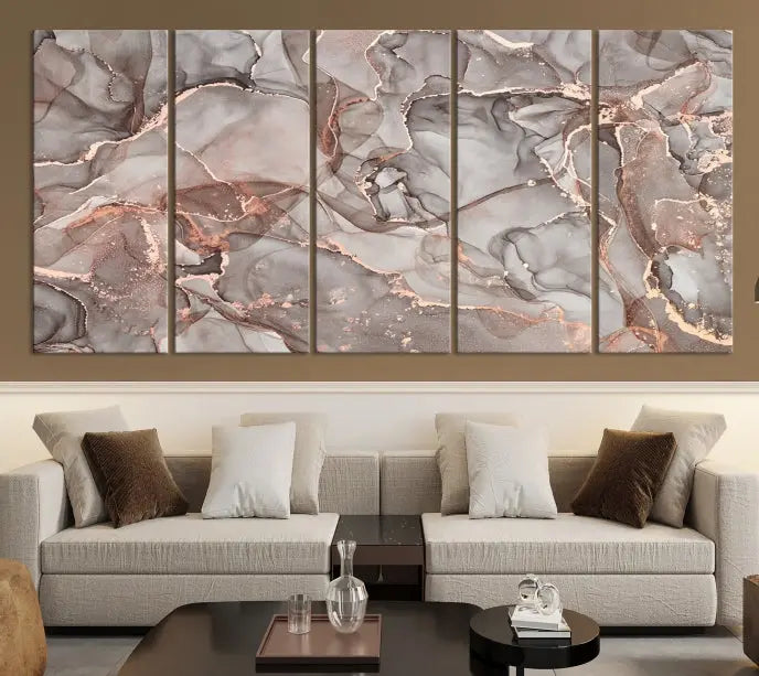 The Rose Gold Marble Fluid Effect Wall Art Abstract Canvas Wall Art Print is an exquisite three-panel creation crafted on museum-quality canvas. It features swirling marbled patterns in shades of gray, copper, and beige. Complete with a UV-protective coating, this ready-to-hang artwork promises to be a timeless addition to any space.