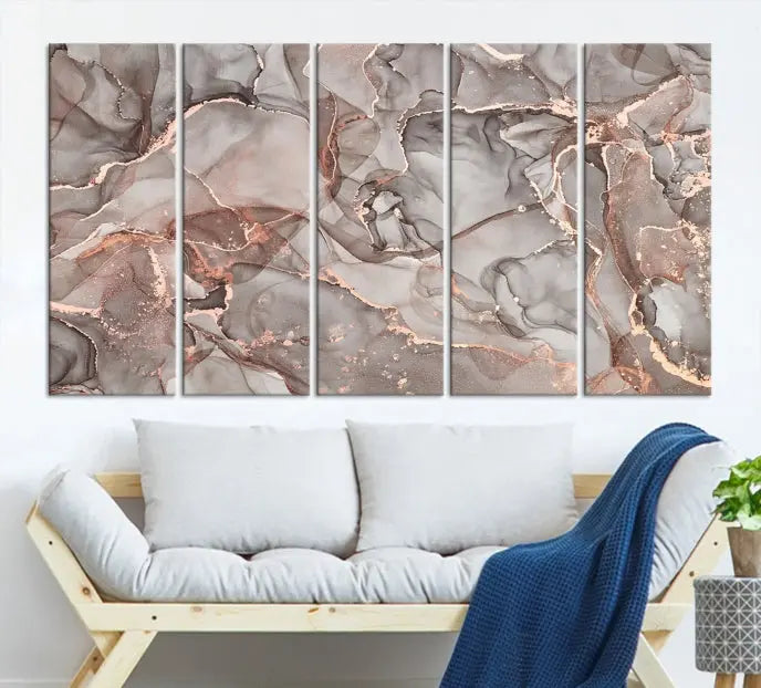 The Rose Gold Marble Fluid Effect Wall Art Abstract Canvas Wall Art Print is an exquisite three-panel creation crafted on museum-quality canvas. It features swirling marbled patterns in shades of gray, copper, and beige. Complete with a UV-protective coating, this ready-to-hang artwork promises to be a timeless addition to any space.