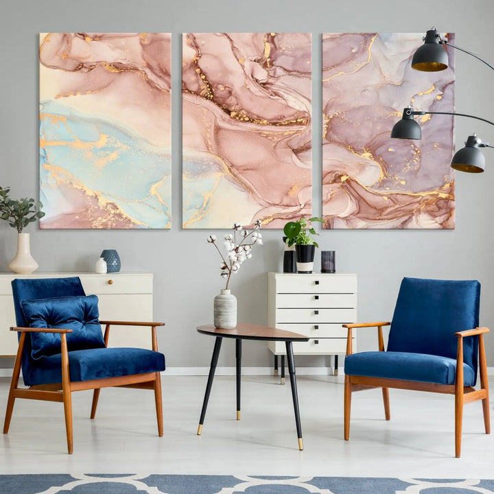 The Rose Gold Marble Fluid Effect Wall Art Abstract Canvas Wall Art Print features stunning pink, blue, and gold streaks to add elegance to your room. Enjoy the museum-quality canvas that resists fading thanks to its UV-protective coating, ensuring lasting beauty.