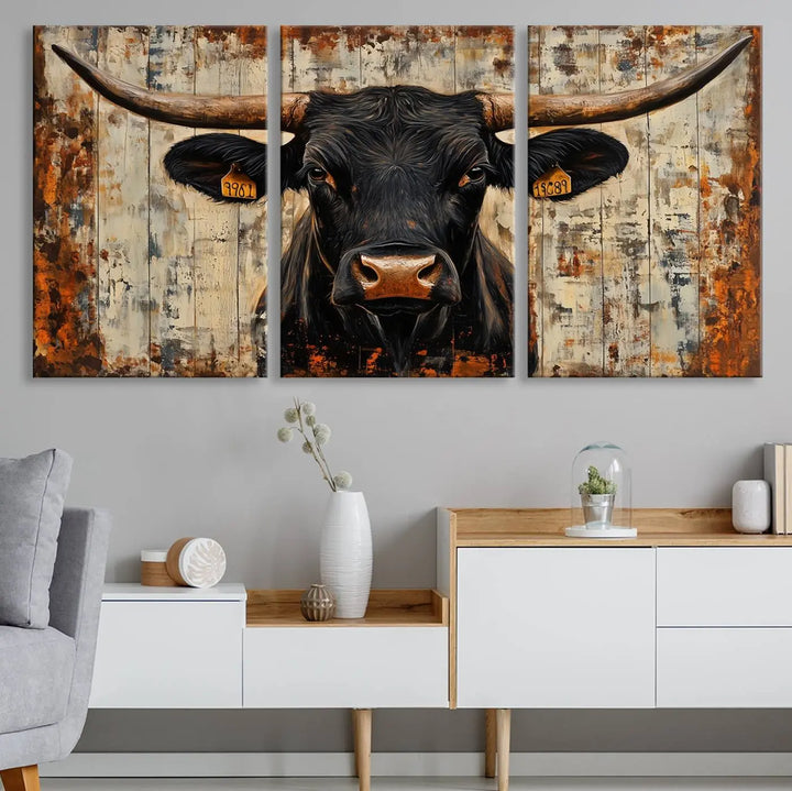 A triptych featuring the "Rustic Texas Artwork Wall Art Canvas Print" showcases an abstract depiction of a majestic longhorn bull with large horns on a textured background, adding a striking touch to the living room. Ideal for enthusiasts of Western home decor.