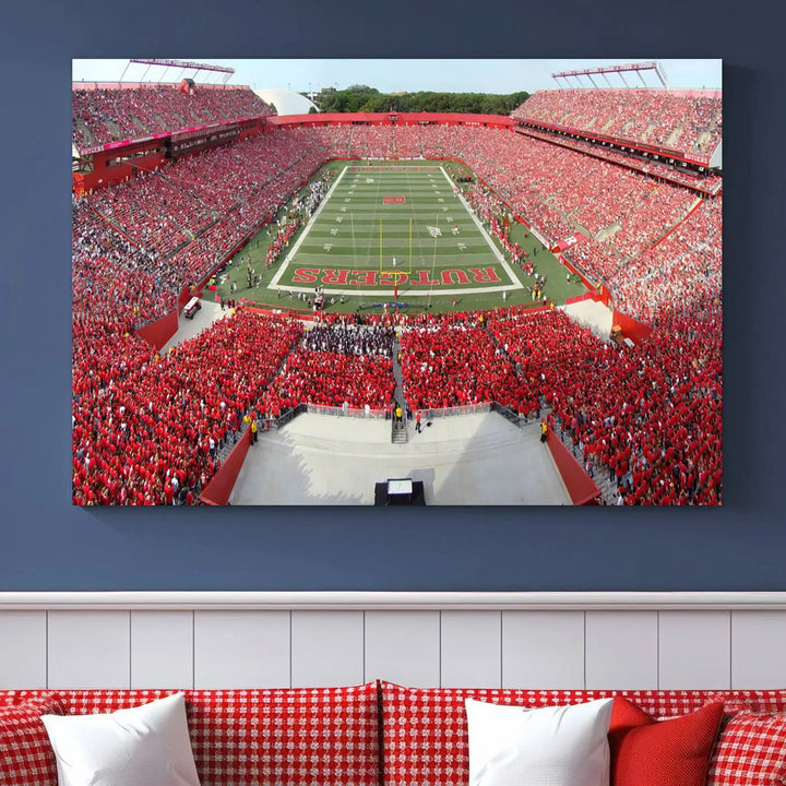 The room features a large wall art piece titled "Rutgers Scarlet Knights Football Team Print - Piscataway SHI Stadium Wall Art Canvas Print." This artwork showcases a vibrant, packed football stadium and boasts a gallery-quality finish on premium canvas, adding an elegant touch to the lively scene.