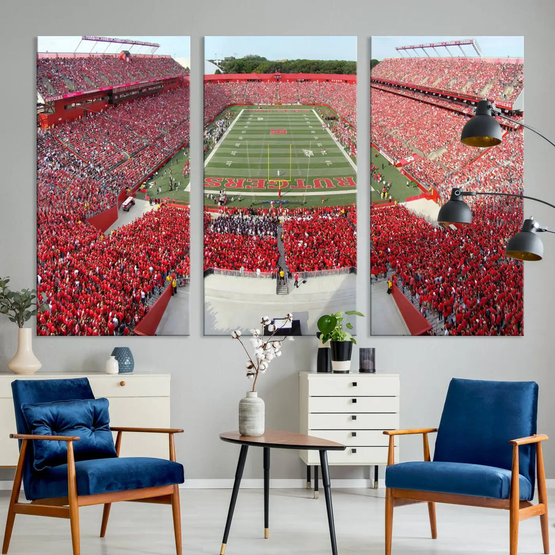 The room features a large wall art piece titled "Rutgers Scarlet Knights Football Team Print - Piscataway SHI Stadium Wall Art Canvas Print." This artwork showcases a vibrant, packed football stadium and boasts a gallery-quality finish on premium canvas, adding an elegant touch to the lively scene.