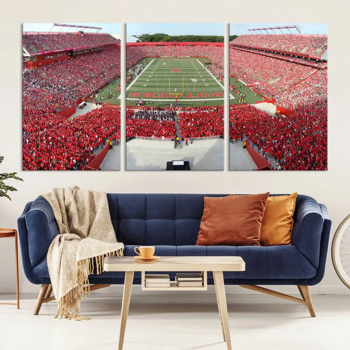 The room features a large wall art piece titled "Rutgers Scarlet Knights Football Team Print - Piscataway SHI Stadium Wall Art Canvas Print." This artwork showcases a vibrant, packed football stadium and boasts a gallery-quality finish on premium canvas, adding an elegant touch to the lively scene.