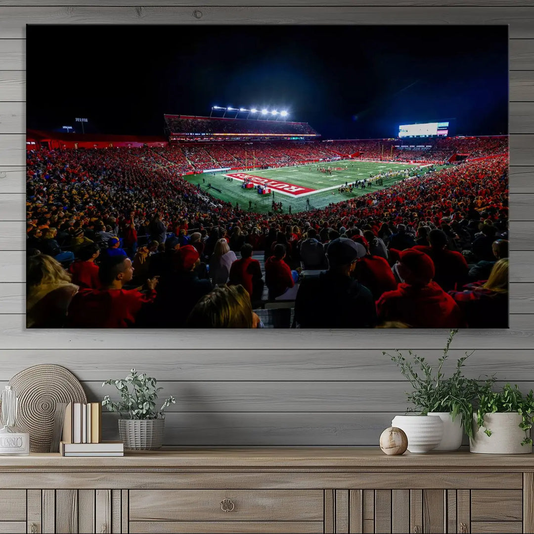 The living room is adorned with a stunning Rutgers Scarlet Knights Football Team Print – SHI Stadium, Piscataway Wall Art Canvas Print. This vibrant stadium scene at night, with its bright lights, offers a gallery-quality finish and adds an elegant touch to the space.