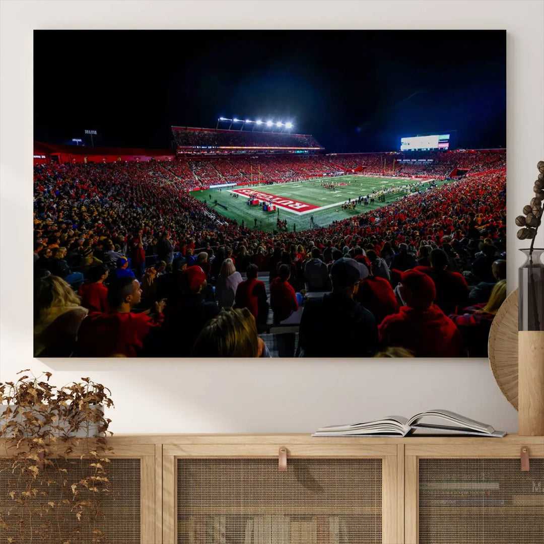 The living room is adorned with a stunning Rutgers Scarlet Knights Football Team Print – SHI Stadium, Piscataway Wall Art Canvas Print. This vibrant stadium scene at night, with its bright lights, offers a gallery-quality finish and adds an elegant touch to the space.