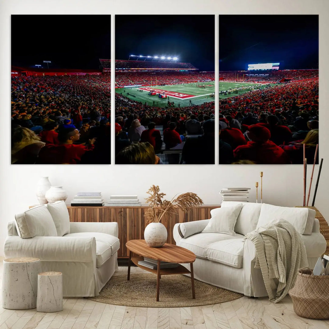 The living room is adorned with a stunning Rutgers Scarlet Knights Football Team Print – SHI Stadium, Piscataway Wall Art Canvas Print. This vibrant stadium scene at night, with its bright lights, offers a gallery-quality finish and adds an elegant touch to the space.