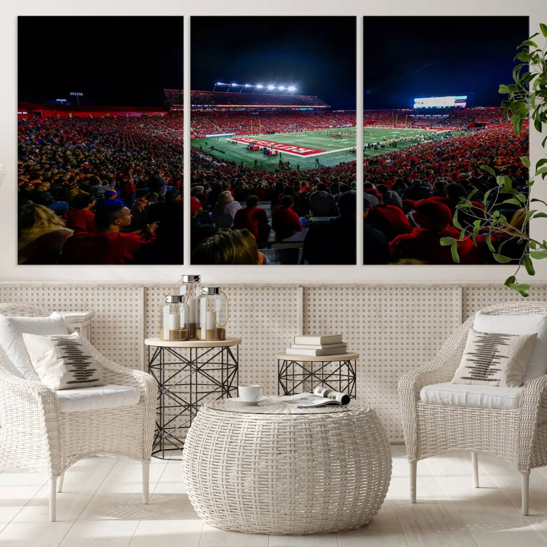 The living room is adorned with a stunning Rutgers Scarlet Knights Football Team Print – SHI Stadium, Piscataway Wall Art Canvas Print. This vibrant stadium scene at night, with its bright lights, offers a gallery-quality finish and adds an elegant touch to the space.