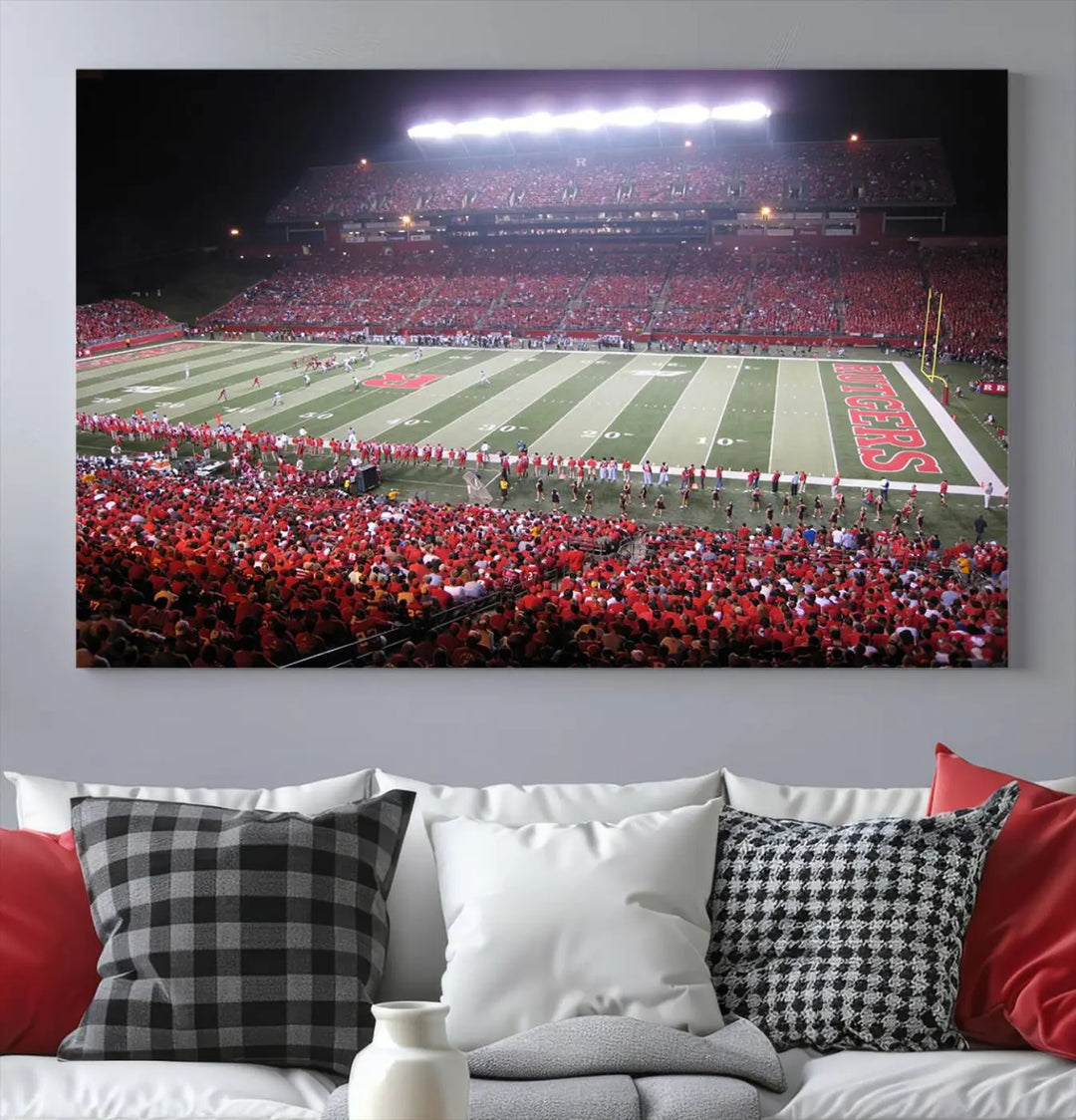 The Rutgers University Scarlet Knights Football Team Print - Piscataway SHI Stadium Wall Art Canvas Print adds an elegant touch to a stylish room. Handmade in the USA, it captures the spirited ambiance of a packed football stadium at night perfectly.